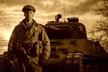 A man standing with his hands in his pockets in front of a tank.